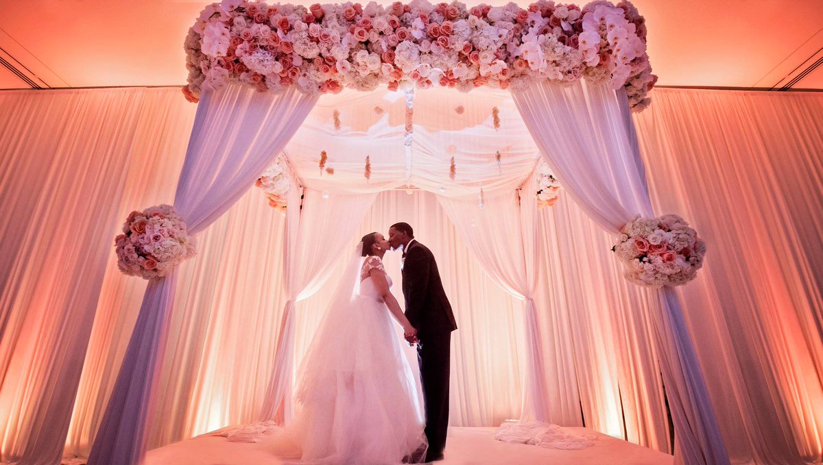 This stunning altar made with elegant white drapery and pink and ivory flowers was the perfect spot for the couple to say "I do!". bit.ly/2DMuuBr <a href="/carascophoto/">Carasco Photography</a> <a href="/KeshDesigns/">Kesh Designs</a> <a href="/TheRomonaKeveza/">Romona Keveza</a> <a href="/BellaBiancaIL/">Bella Bianca Bridal</a>
