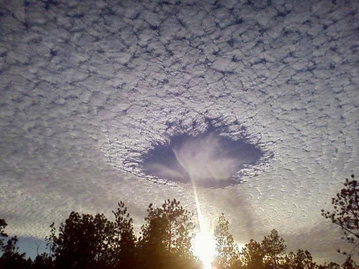 This is real! It's a fallstreak hole, a rare meteorological phenomenon