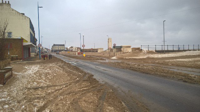 HpoolCouncil's tweet photo. Take great care when travelling along the A178 Coronation Drive in Seaton Carew. Exceptionally strong winds are blowing in off the sea and are also driving massive amounts of sand onto the road and pavements. Our cleansing teams are working continuously to keep the road open. https://t.co/vbsjVTeozE