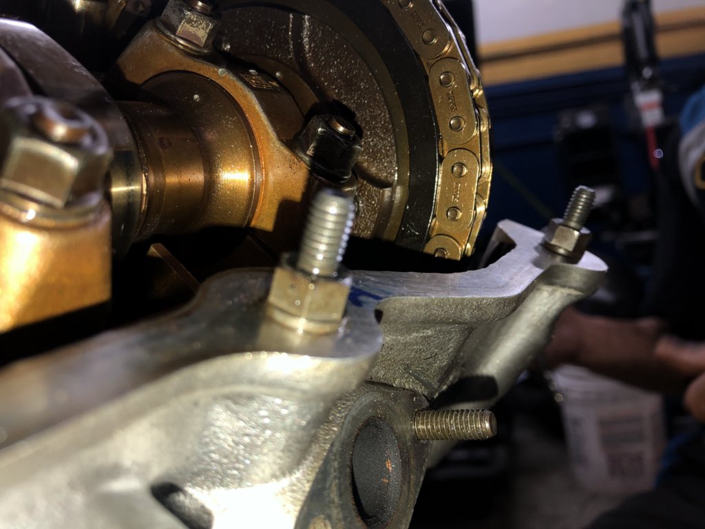 The camshaft alignment tool and arrow on sprocket aligned with the lining on the cylinder head. Complete.
