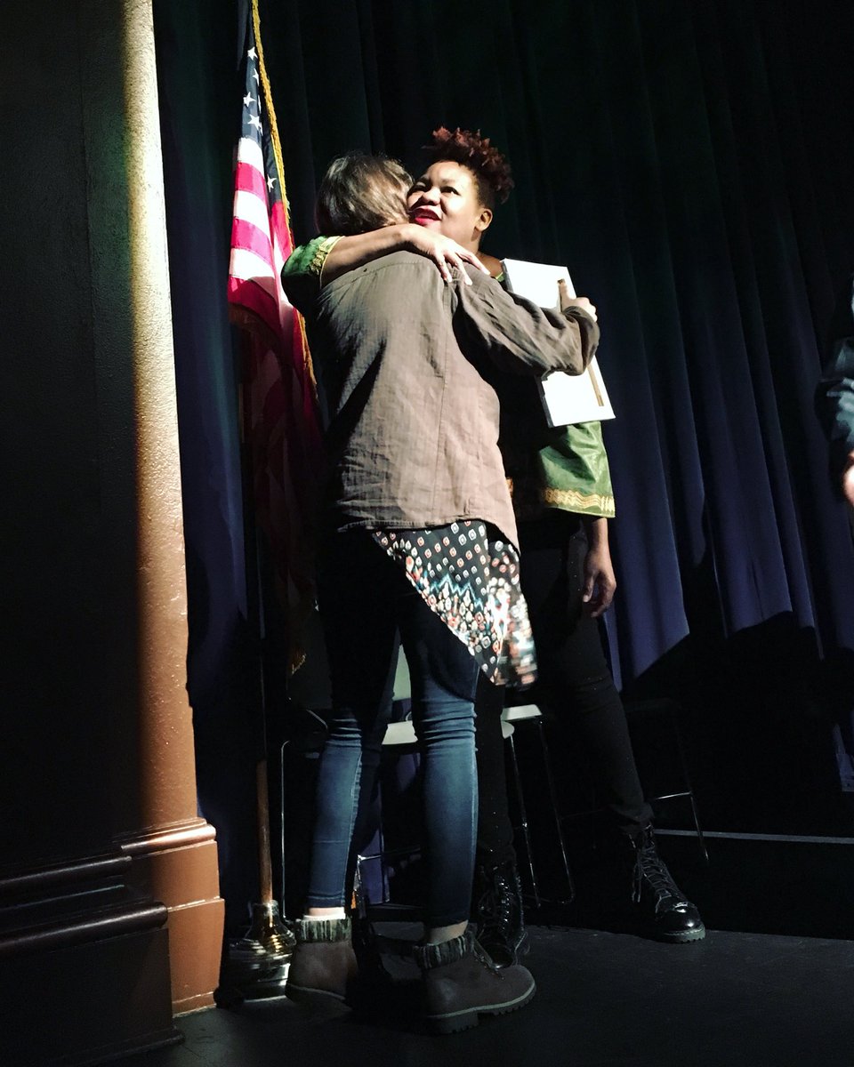 AllWriteWGHS's tweet photo. Tea Gardner presents Treasure Shields Redmond with an original piece of art. Redmond read and sang to 1st hour this morning—poems and lyrics inspired by Fannie Lou Hamer. It was a history lesson and emotional experience all in one. #AllWrite2018 https://t.co/CiDUgKrpJK