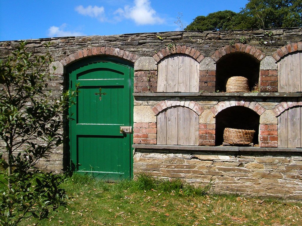 Bee boles kept the skeps out of rain and wind, and the stored heat of the sun warmed stone would help create a beneficial microclimate for the bees. Boles would always be aligned to the east or south, to make the most of the sun. They were common in brick walled gardens.