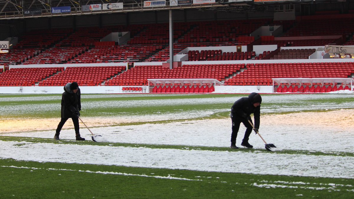 NFFC's tweet photo. ❄️ The #NFFC ground staff and academy players are working hard to clear the pitch and the stands at The City Ground to ensure tomorrow's game against @BCFC goes ahead.

#ThatLovingFeeling https://t.co/QeB09KAyIj