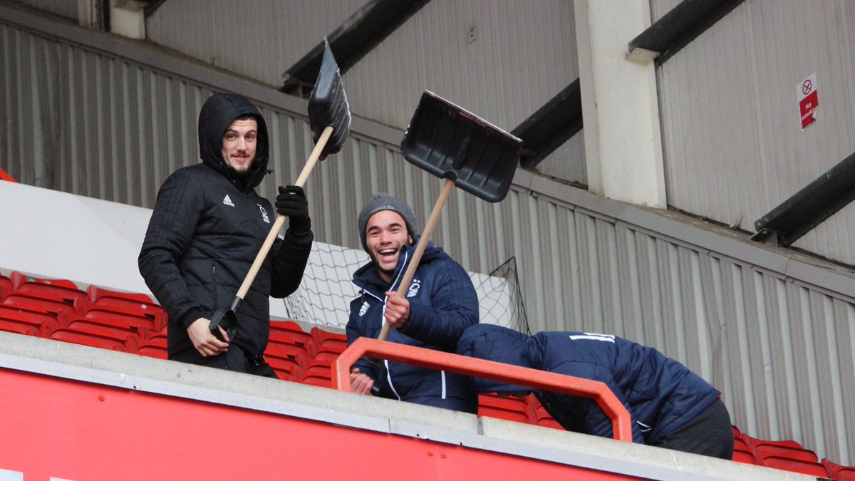 NFFC's tweet photo. ❄️ The #NFFC ground staff and academy players are working hard to clear the pitch and the stands at The City Ground to ensure tomorrow's game against @BCFC goes ahead.

#ThatLovingFeeling https://t.co/QeB09KAyIj