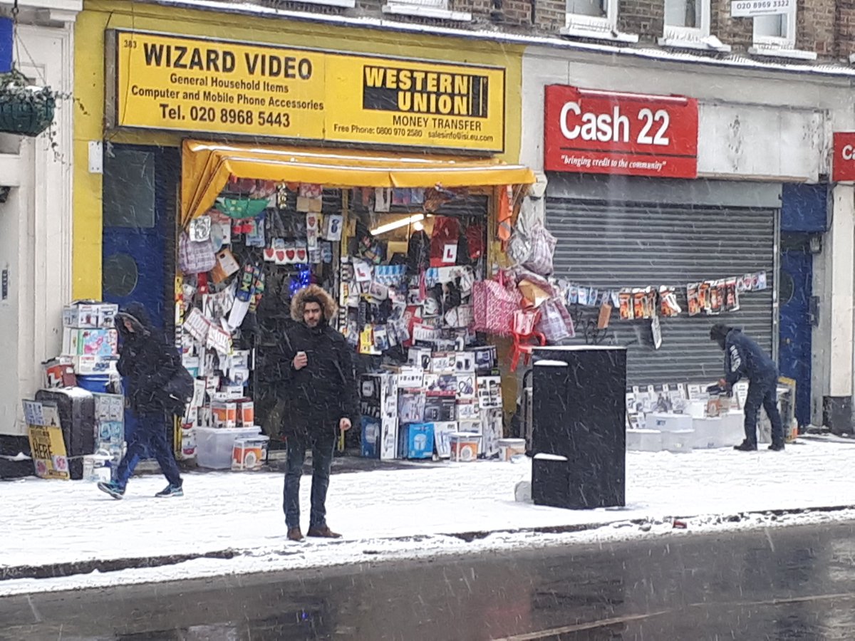 west9er's tweet photo. Come #snow/sleet/ice/frozen rain... Mr #WizardVideo will always have his wares on display. You can rely on that! #HarrowRoad #London #W9 #snowuk https://t.co/Eppwn686tU