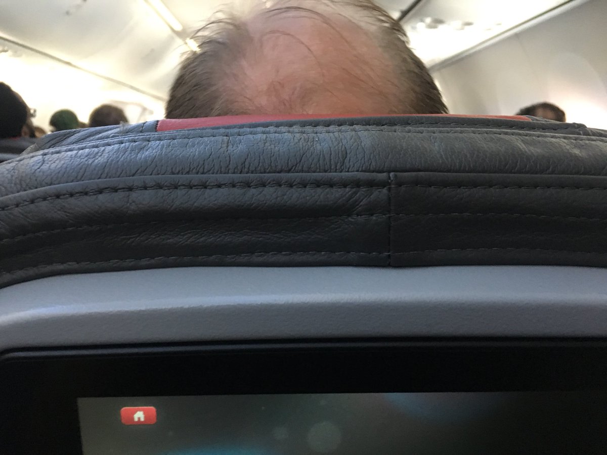 buddys's tweet photo. When the guy in front of you decides to recline his seat and there’s no place for you to go… It even makes the in seat back  entertainment screen hard to view... then you’re stuck looking at his bald head for three hours #AmericanAirlinestightseating https://t.co/o3v2Kvi2LN
