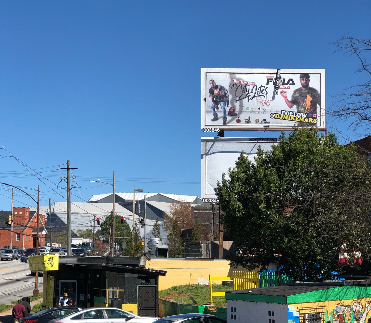 TreeHuggerNat's tweet photo. Big shoutout @Djmikemars wearing the camo #TreeHuggerNation Tree tee on his #FilaParty billboard downtown Atlanta! Shop with 🌲🐻 at https://t.co/5XUK7tO4z2 ‼️ https://t.co/C2Vcbil37T