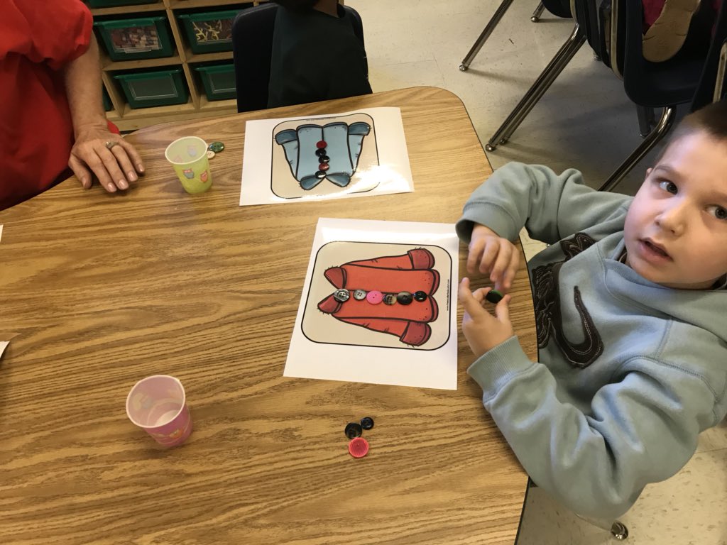 Prek learning to count and place buttons using a dice