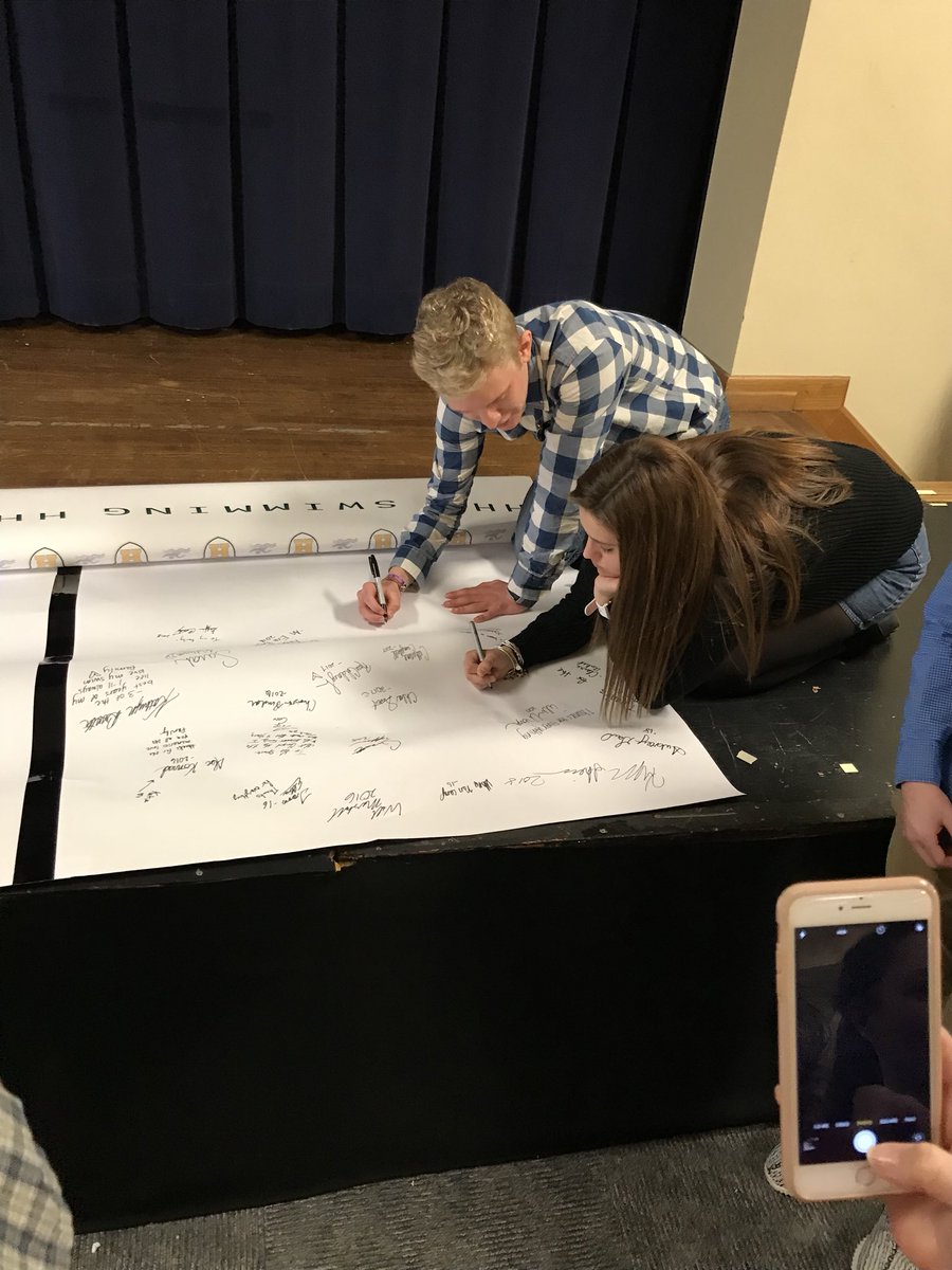 HHS_Swimming's tweet photo. Joining seniors of years past - signing the back of the photo backdrop. @ethancade8 @kxitlynhxll https://t.co/JRJImp3XFh