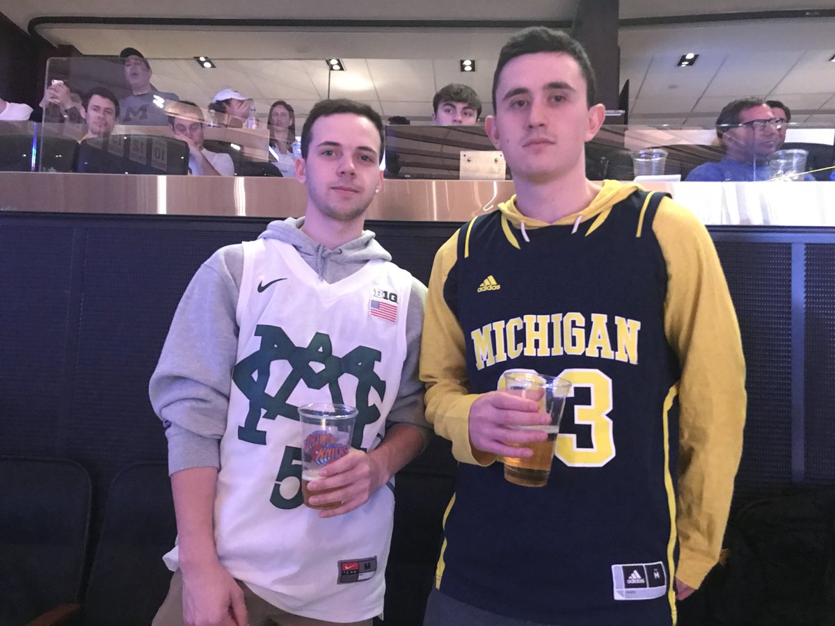 MichiganOnBTN's tweet photo. The beauty of the #B1GTourney ... These two fans are strangers seated next to each other and neither would smile for the picture because of the rivalry. The hate is real: https://t.co/P2DZ3AXigy