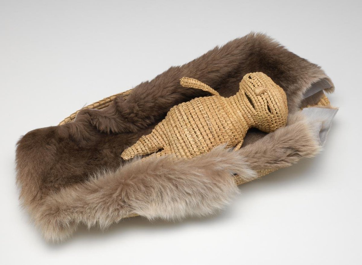 another of Yvonne Koolmatrie's pieces, 'Weaver's baby in coolamon' (2008) — the woven material is sedge, the fur is kangaroo