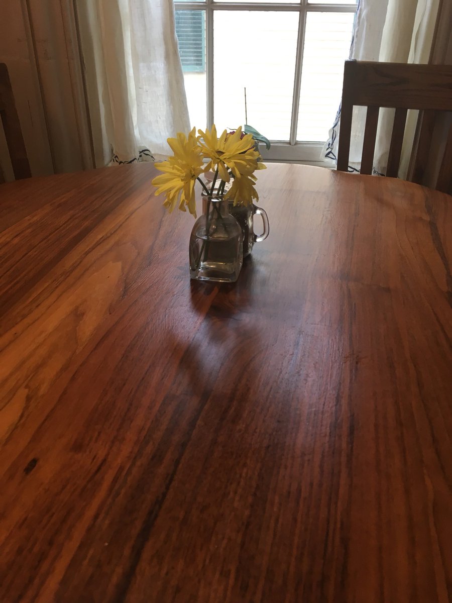 A hand hewn wooden table, with flowers in the center, near a window, and WiFi. #heavenly