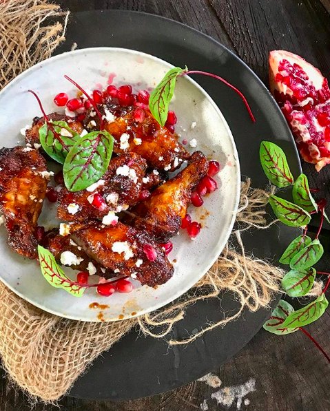 Sweet and sticky pomegranate molasses and soy wings tossed with feta from <a href="/nancyscravings/">Nancy Crocker</a> – this might be the prettiest plate of wings we’ve ever seen!😍