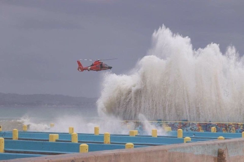 A Coast Guard Air Station Borinquen MH-65 Dolphin helicopter crew arrives at Crash Boat Beach, Puerto Rico to hoist a man from the water who reportedly suffered a wrist injury Mar. 4, 2018. The aircrew transferred him to emergency medical services in Air Station Borinquen.