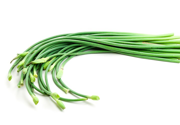 Only one ineSCAPEable conclusion: those are garlic scapes, the edible flower stalks of the garlic plant. They can be used any way you'd use scallions. Look for them in farmers markets and specialty markets in late spring here in CA, the nation's top garlic-producing state.