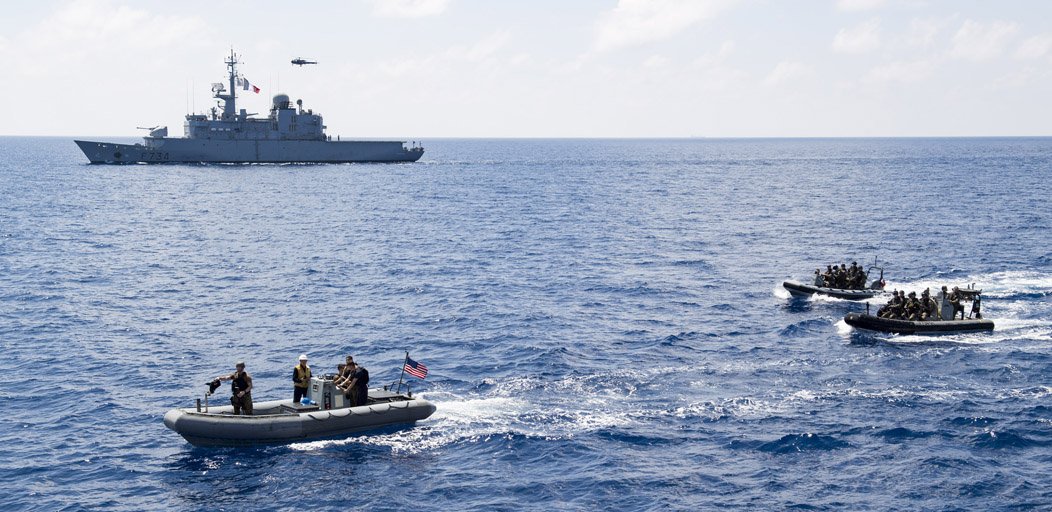 USPacificFleet's tweet photo. Sailors from #USSMichaelMurphy and the French Navy frigate FNS Vendemiaire approach #DDG112 during visit, board, search and seizure (VBSS) drills as part of a passing exercise (PASSEX) in the South China Sea, March 4. #3rdFleetForward #Partnerships @MarineNationale https://t.co/dXVDdcqqVL