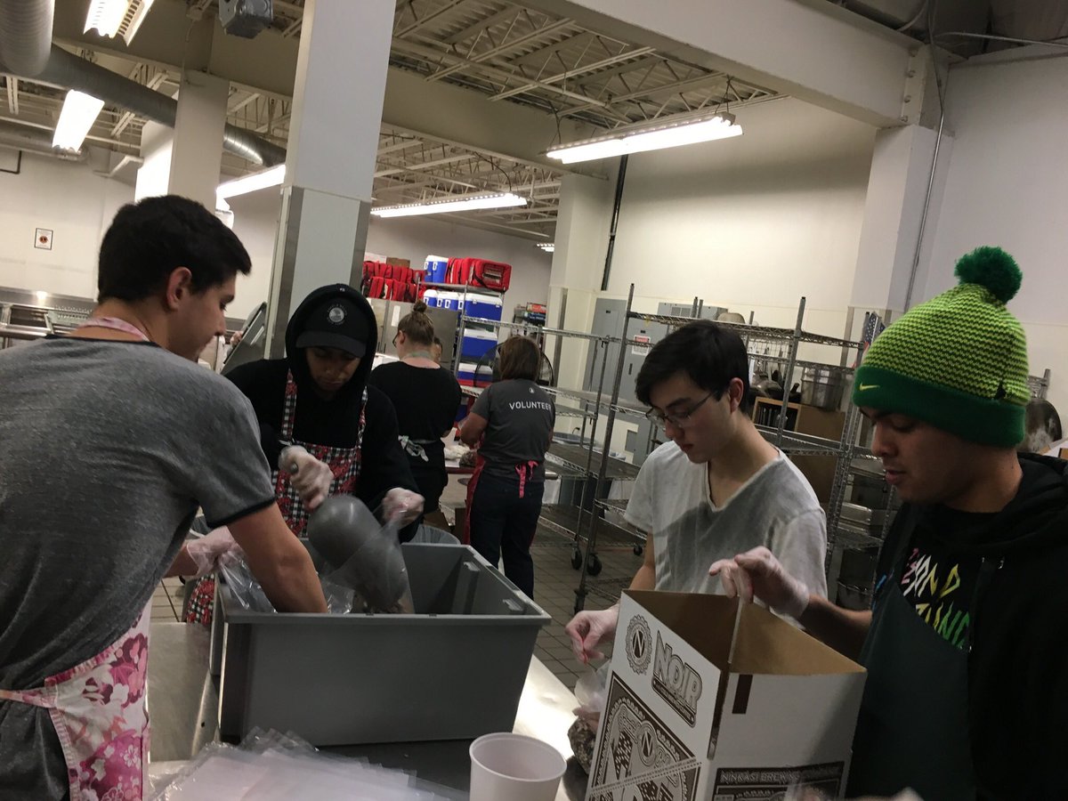 Volunteering at Food for Lane County is very rewarding; here are some brothers packaging boxes of food for local families.