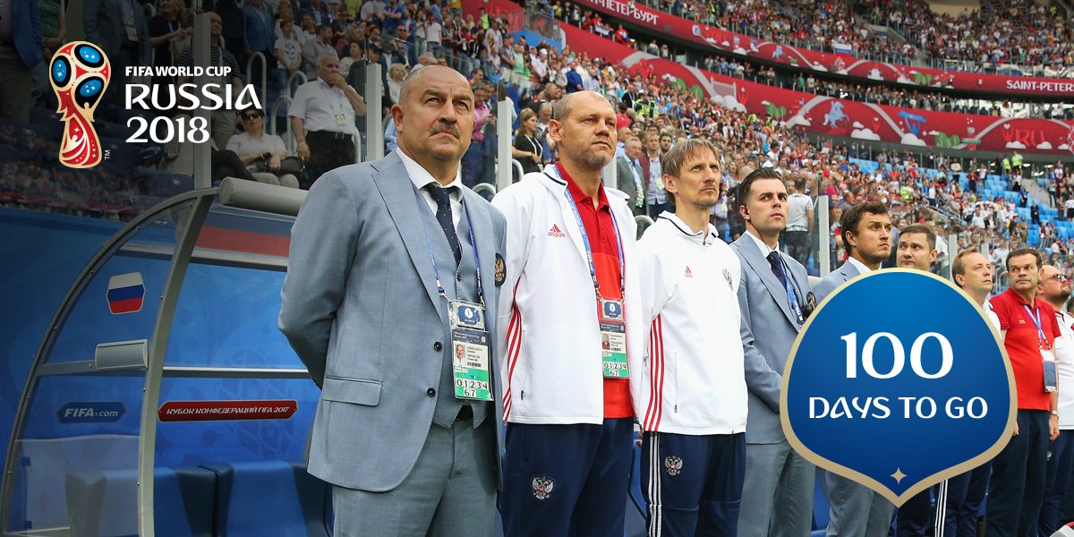 Russia coach Stanislav Cherchesov and his coaching staff stand before kick-off.