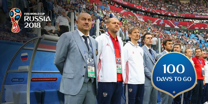 Russia coach Stanislav Cherchesov and his coaching staff stand before kick-off.