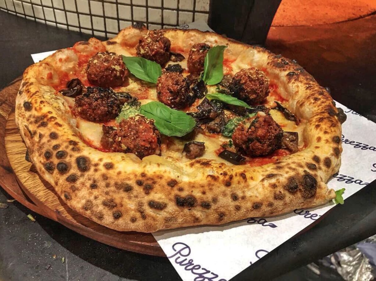 New vegan meatball pizza has officially landed on the specials menu at Purezza. Grab this one for a limited time only. #veganhour