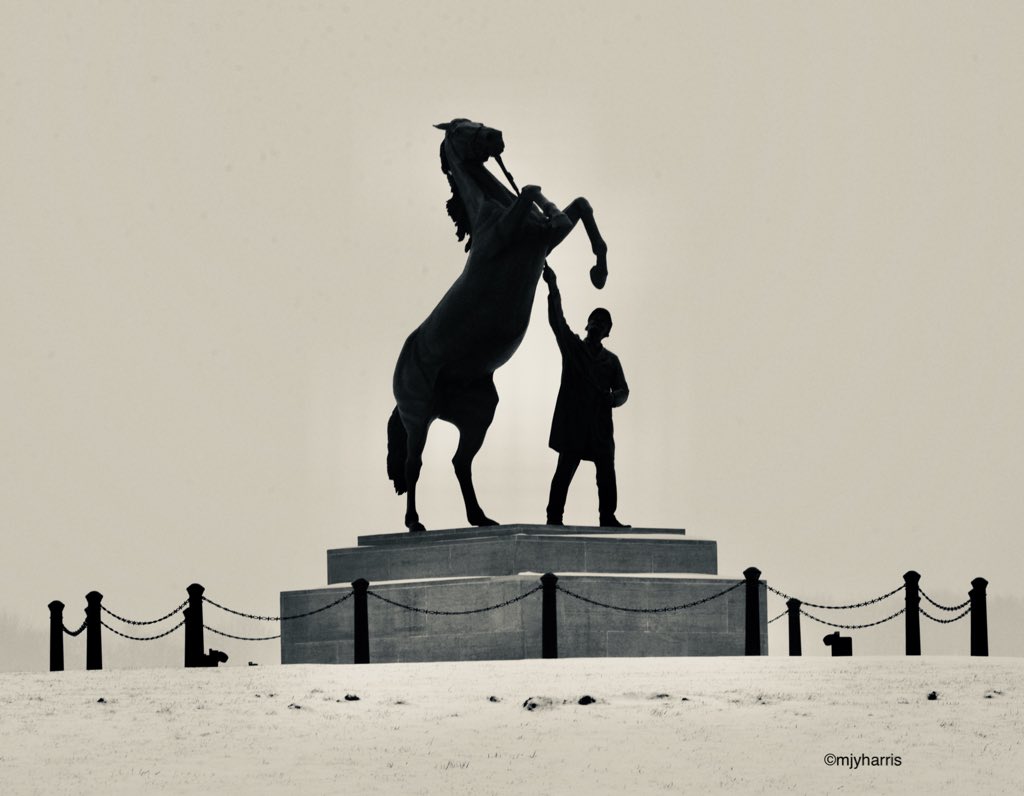 The statue of the rearing stallion and his handler that is on the roundabout outside the July Course/The National Stud, Newmarket, in the snow last week.