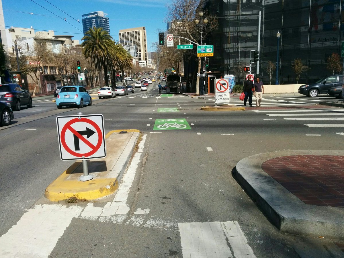 Market NE at Octavia: 5'7". The island was added to stop drivers from making the illegal right turn and killing bicyclists. I don't think it worked until the big gun was rolled out: photo enforcement. And that apparently required a change in state law.