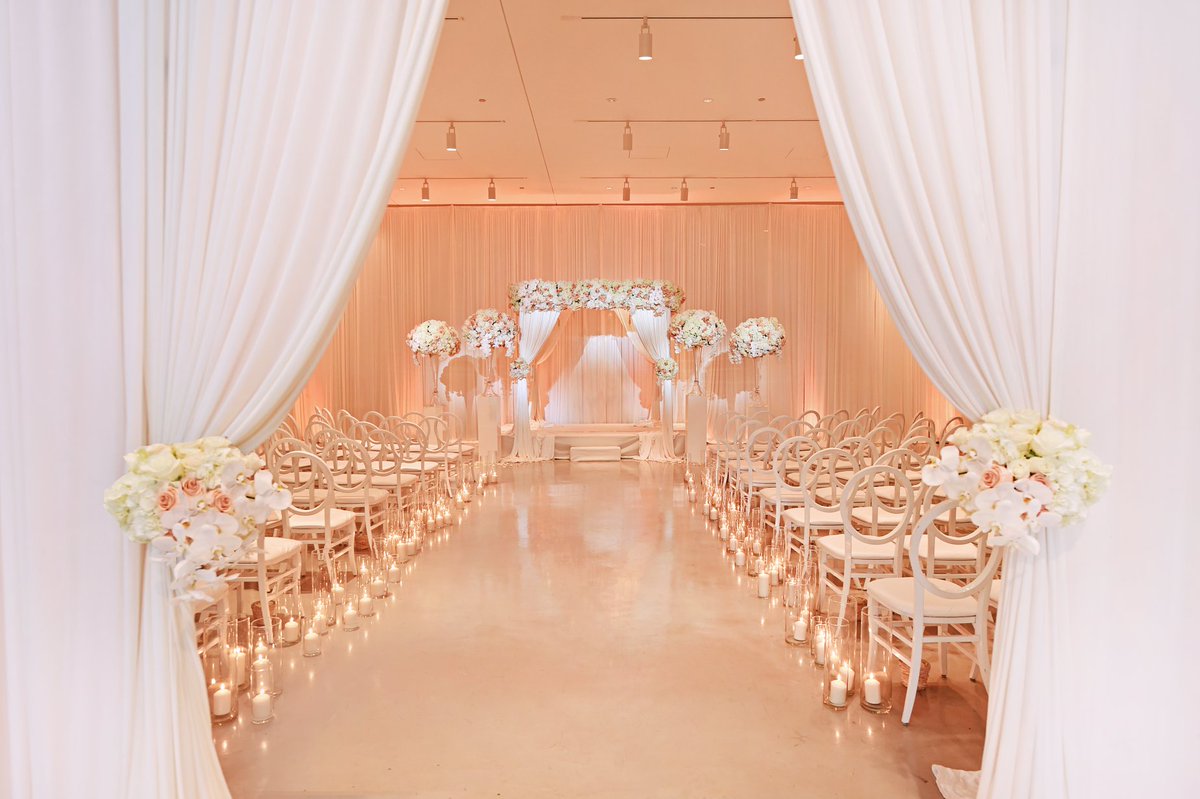 Guests walked through white curtains held by floral arrangements to enter the ceremony space. bit.ly/2DMuuBr <a href="/carascophoto/">Carasco Photography</a> <a href="/KeshDesigns/">Kesh Designs</a>