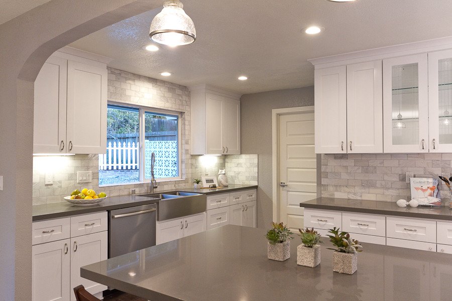 This beautiful kitchen from <a href="/NextGenHomesCA/">NextGenCap</a> pairs white cabinetry with smooth #Silestone Cemento surfacing for a classic look.