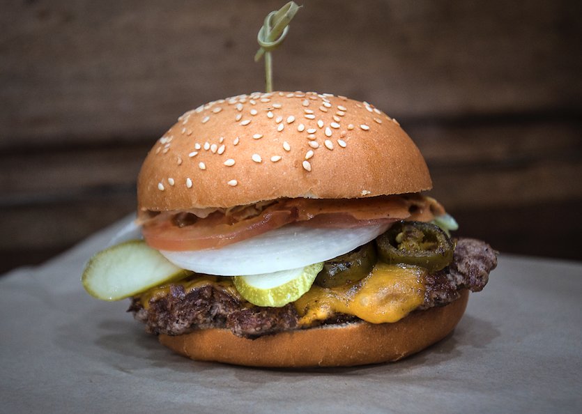 Have you tried our Trouble Burger? It's a delicious combination of 100% beef patty, cheddar cheese, tomato, lettuce, onions, pickles, grilled jalapenos, ancho chipotle sauce!