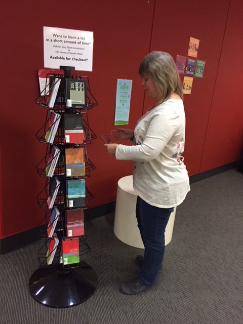 LFClibrary's tweet photo. Librarian Pam Cipkowski setting up our new collection of informative quick reads: 33 1/3 books on popular music and Very Short Introductions on all sorts of topics. On the lower level. Stop by and check them out! https://t.co/ykRVcn06yI