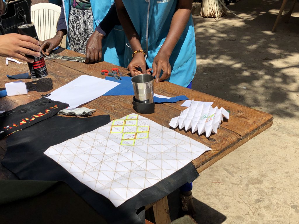 panurban's tweet photo. Making progress on our end! The #Spacecraft #origami-#kente-style soft and kinetic 3D envelope low-fi prototypes with the help of wonderful women from the neighboring sewing school @xamxam_org @sociarchi @africanurbanism @dkoa @qampnet  @kerthiossane https://t.co/b2gV71o036