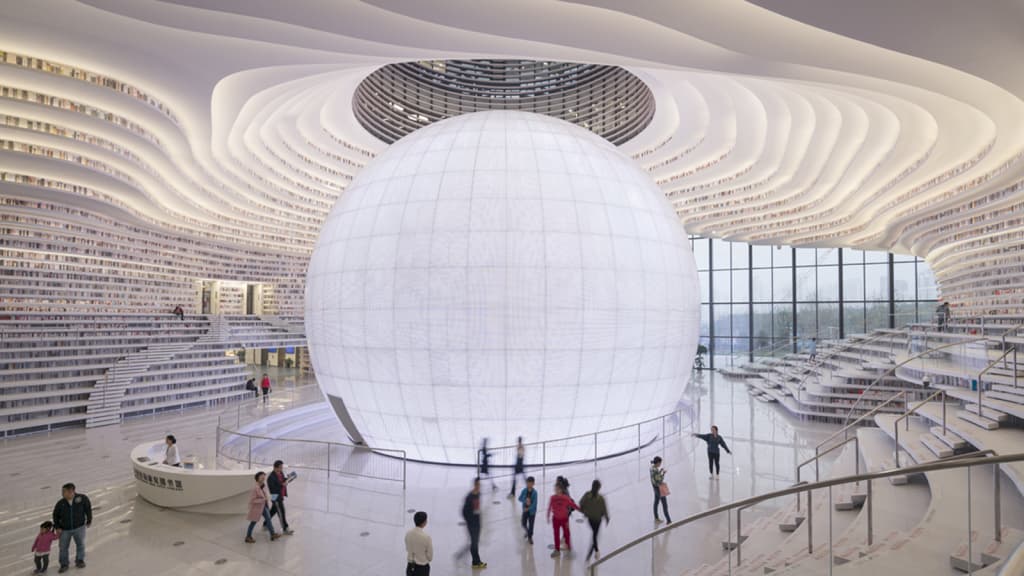 AsiaReviews's tweet photo. New Tianjin Binhai Library in China is a spherical auditorium w/ floor-to-ceiling bookcases. The undulating bookshelves frame the space to create stairs, seating, & a layered ceiling #BucketList #BucketListProject #Breathtaking #booklovers @MissPandaChines @HistoryTeachJJ #Asia https://t.co/3ndUR9JOW5