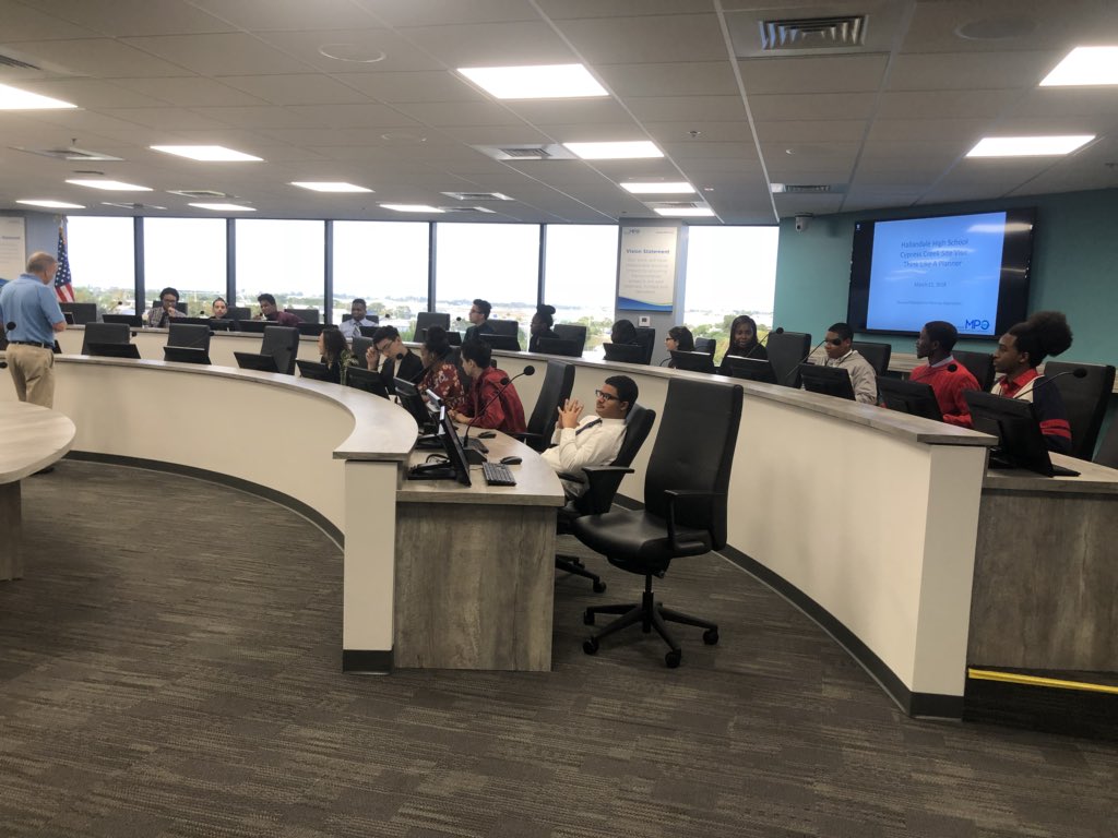 SpeakUp_Broward's tweet photo. .@Hallandale_High is in the #BrowardMPO office today for Round 3 of #ThinkLikeAPlanner. Students get a feel for sitting at the dais. Who knows... they may sit here one day! https://t.co/KK5Uzm5XB9