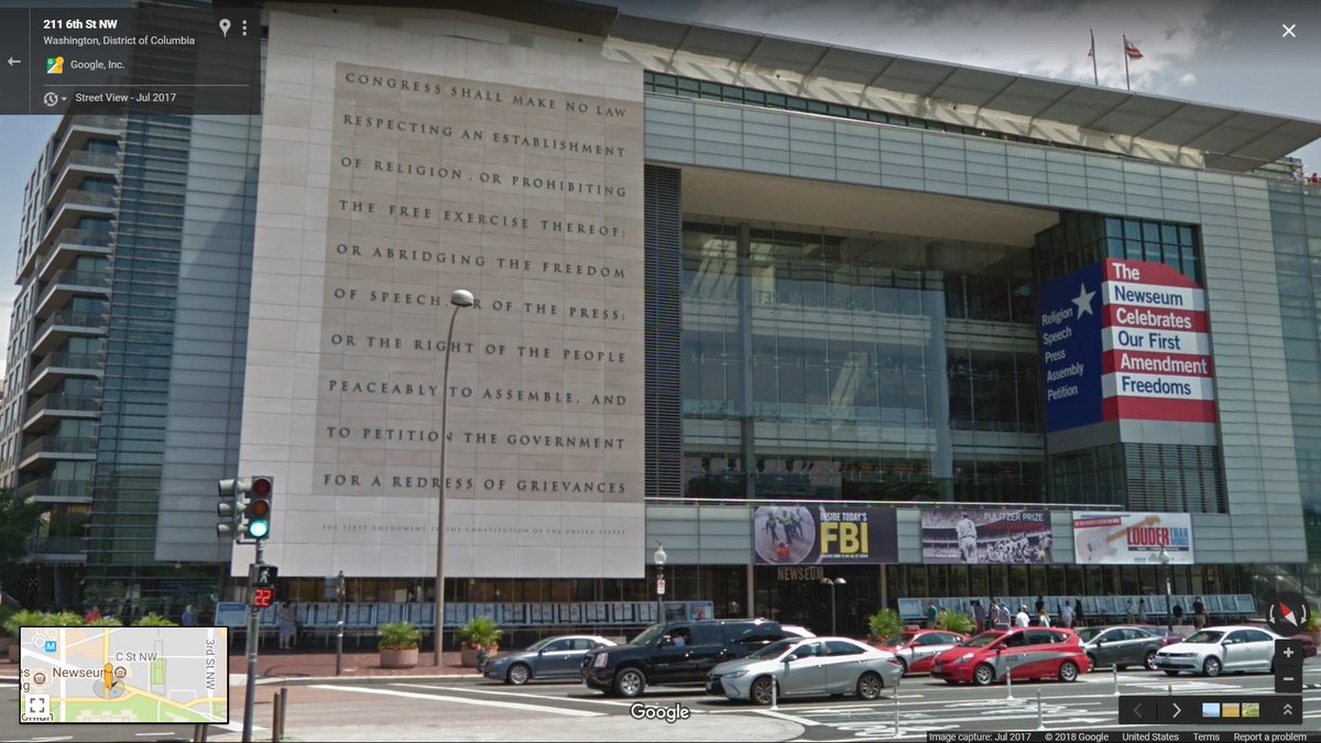 Exterior of the Newseum on Pennsylvania Avenue in Washington, DC showing the First Amendment of the Constitution chiseled in stone.