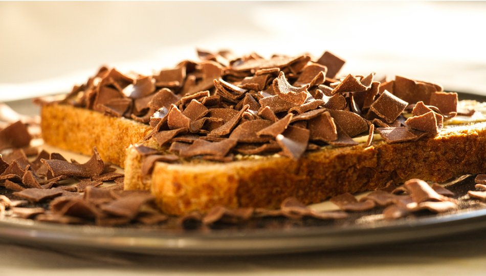Dutch people love eating chocolate sprinkles and flakes on buttered bread. This tradition arose as a practical solution for our butter and milk surplus, which was accompanied by a shitload of cow dung. Mix all these ingredients with a little cocoa and you get "choco-vlokken".