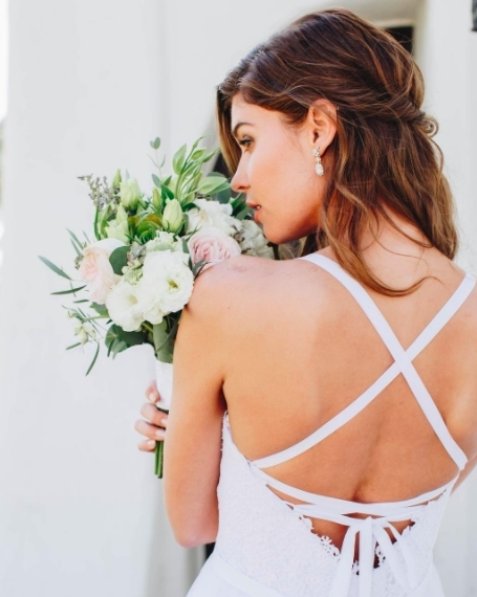 Glamour and grace are radiating off of this gorgeous #bridetobe! (Photo: @nicolebalsamophoto, Earrings: Erica Koesler Dresses: <a href="/iheartazazie/">Keily Hernandez</a>, Flowers from <a href="/fiftyflowers/">FiftyFlowers</a>, HMU: <a href="/pagebeauty/">page</a>, Venue: @olehansonbeachclub)