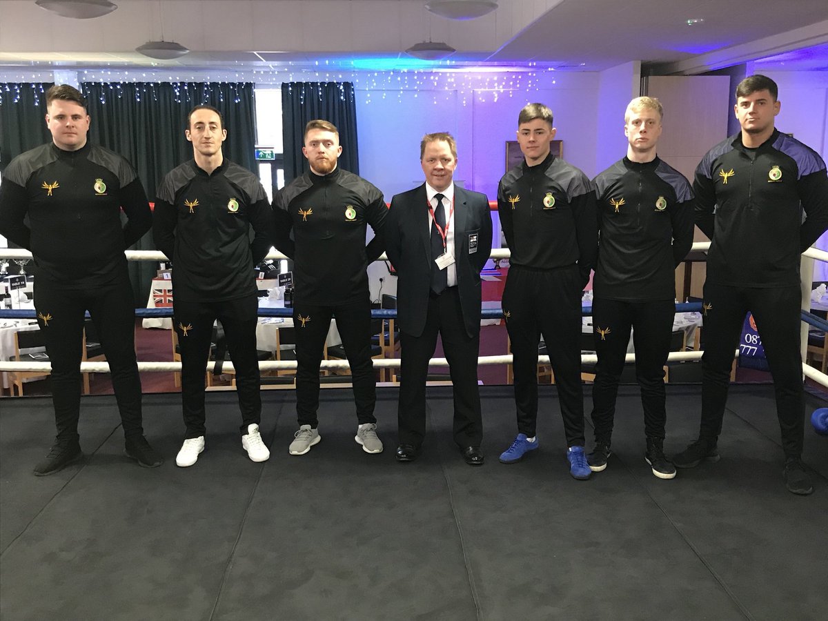 7 members of the boxing squad in their team attire.