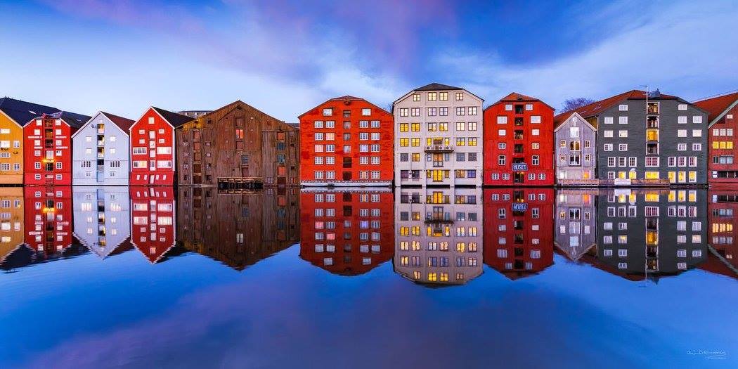 🇳🇴 | Norveç, Trondheim’daki bu renkli binaların berrak sudan yansıyan görüntüsü hoş bir illüzyon oluşturuyor.  #Fotoğraf: Øyvind Blomstereng