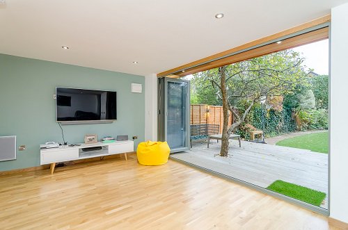 Multi-use garden room in Twickenham. 'We wanted a space that could be used for several purposes: an office for myself, a space for the kids to play music, relax and be with friends removed from the main house and a place to entertain in the summer.'