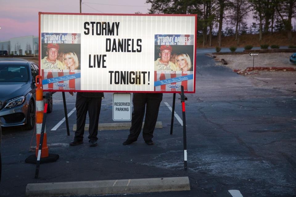 KimKlein's tweet photo. @modestproposal1 Kevin D. Liles, Employees of The Trophy Club arrange letters on the marquee outside the club in Greenville, S.C., before an appearance by Stormy Daniels in January 2018. https://t.co/DYYEWGeLq1
