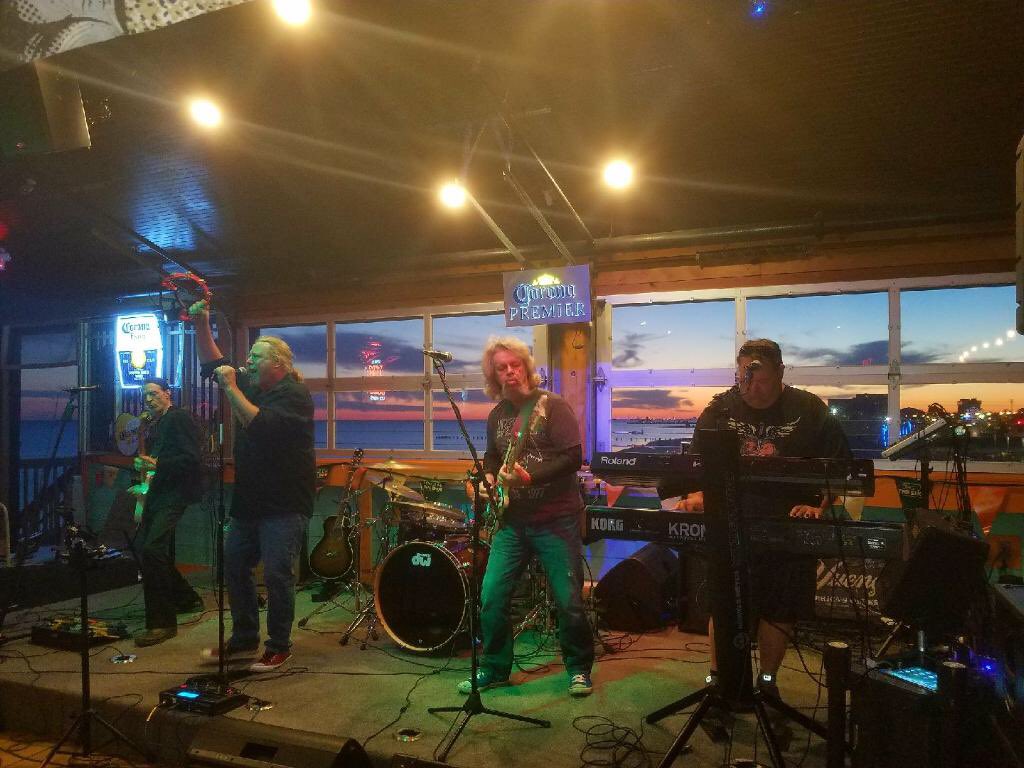 Local group Level Up entertain #MeetingsQuest attendees at the Opening Reception at The Sky Bar at The Reef in front of a beautiful Gulf Coast sunset. @VisitMSCoast