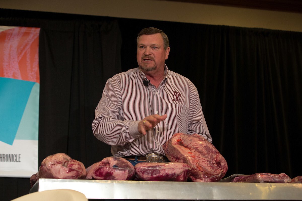 Presenter holder a brisket on stage