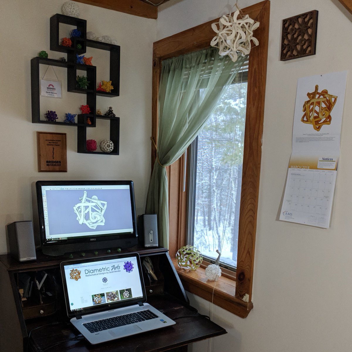 DiametricArts's tweet photo. My new setup, optimized for #inspiration! My art is on the wall with my @BridgesMathart award. My 12Pi sculpture is on the @amermathsoc calendar, hung next to #mathart by @vyrin. A @curvahedra sits on the windowsill.  It's time to move forward! #NoFear @shapeways @SketchUp https://t.co/OxOPP1kjmE