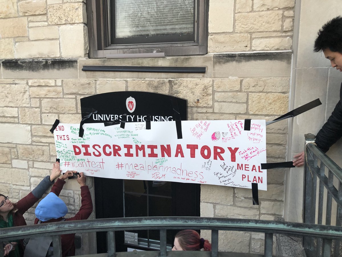 abbsdoeden's tweet photo. .@BadgerHerald Second UW student meal plan protest parades through Four Lakes Market, signsposter against plan, marches to University Housing office and hangs poster on door. https://t.co/grUZqtdnE1