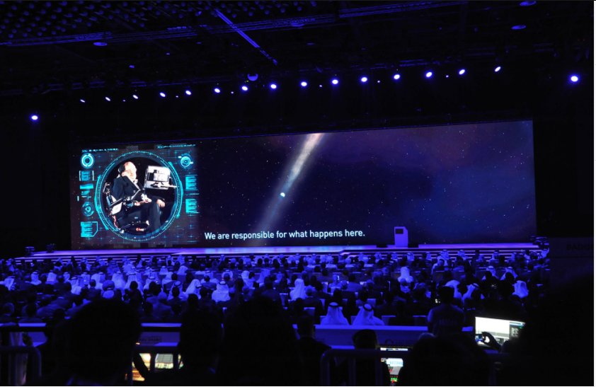 TMHDubai's tweet photo. We are sad to hear about Stephen Hawking's death. It was an honour working with him as a speaker at the recent Abu Dhabi Sustainability Week. What a legend. #ADSW2018 #StephenHawking https://t.co/0ZjzTlm2Pc