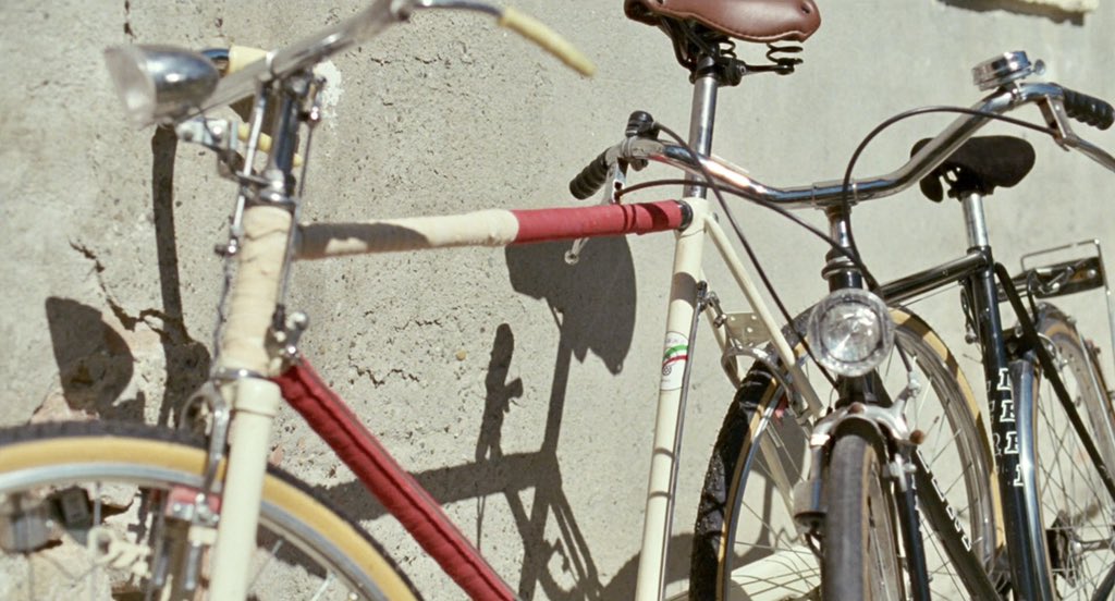 ( #13)remember that scene where Elio slips the note?after that scene it jumped into morning setting, then it focused on their bikesyou know that long metal thing beneath the bike seat? its called a seatpost. its used to adjust the height of the seatadjust...mmm...
