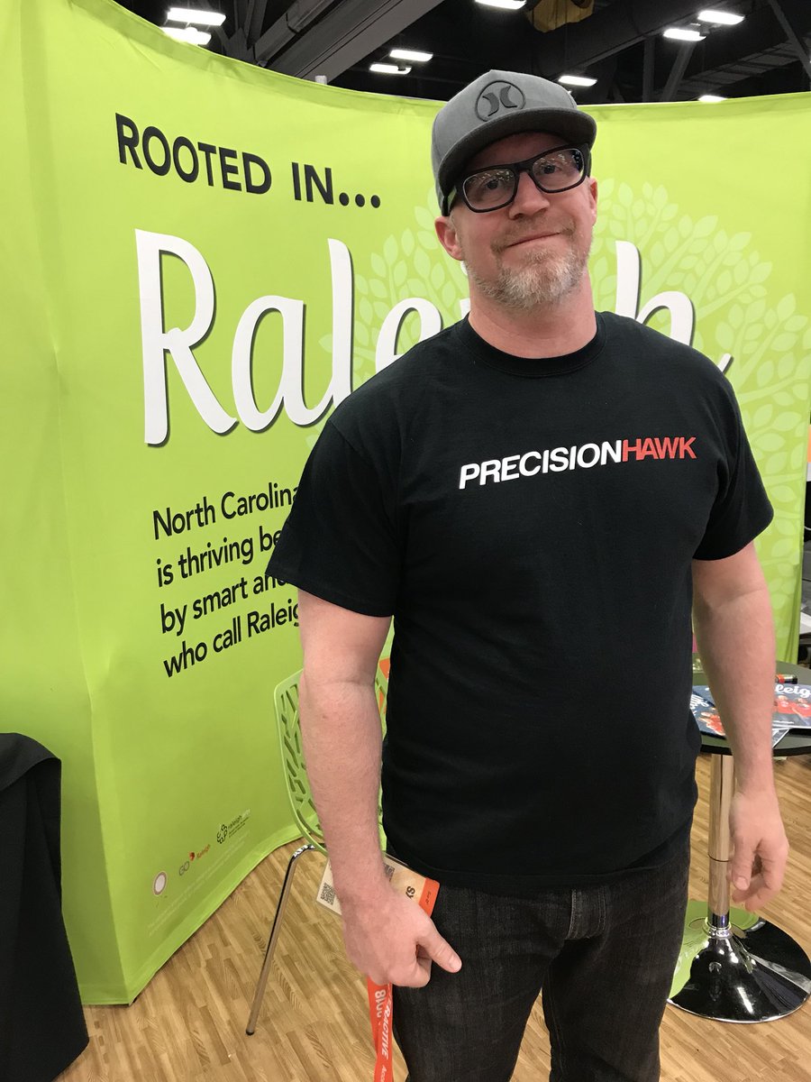 DerrickMinor's tweet photo. Final day of the trade show and excited to wear my @PrecisionHawk swag. They are one of Raleigh’s fastest growing companies and offer one of the most advanced enterprise level drone platforms in the world. Thanks @LiaReich for the shirt! #Raleigh2SXSW https://t.co/JgEygGeikg
