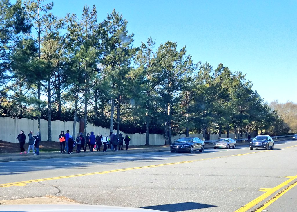 PortiaFOX5's tweet photo. Happening now in Cobb Co: Parents of Lassiter H.S. students stand across the street in support of #NationalSchoolWalkout day. Students tell us several classmates plan to walk out silently and protest on the football field. @FOX5Atlanta See full coverage on https://t.co/nMSo8Yv6ES https://t.co/nn0H6sGICX