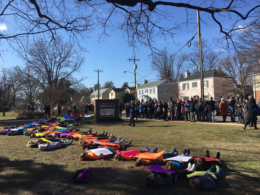 loisbeckett's tweet image. Every student at this walkout suddenly lay down and now their parents are watching and taking photos of this and everyone is totally silent.