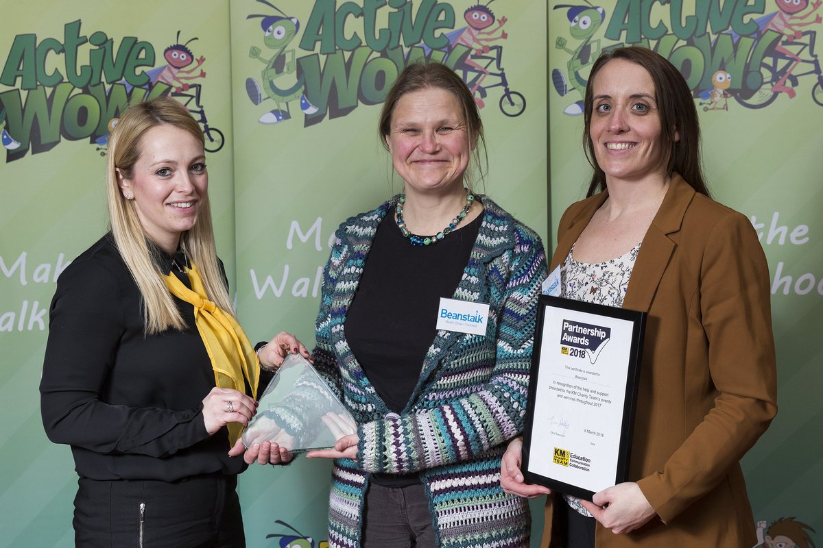 BeanstalkSEast's tweet photo. We've just received the official photos from last week's @KMCharityTeam Partnership Awards 2018! Here's Malou, our Area Manager, and Steph, our Area Team Leader with our award! #readgrowthrive #partnerships @beanstalkreads https://t.co/w8xxVdUhMv